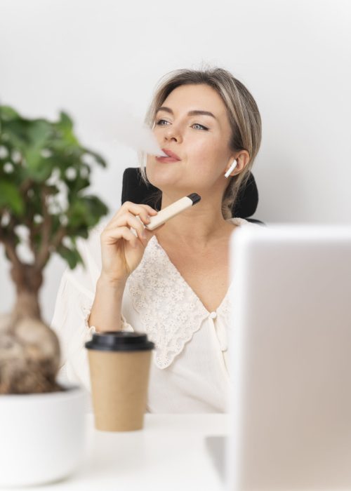 medium-shot-business-woman-vaping